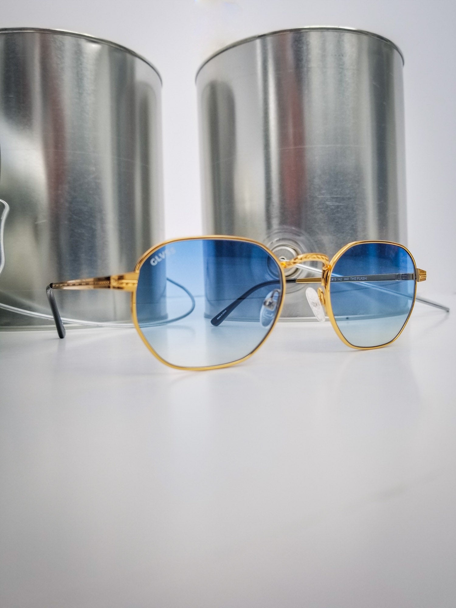 Glvss ; the flash , gold blue lens